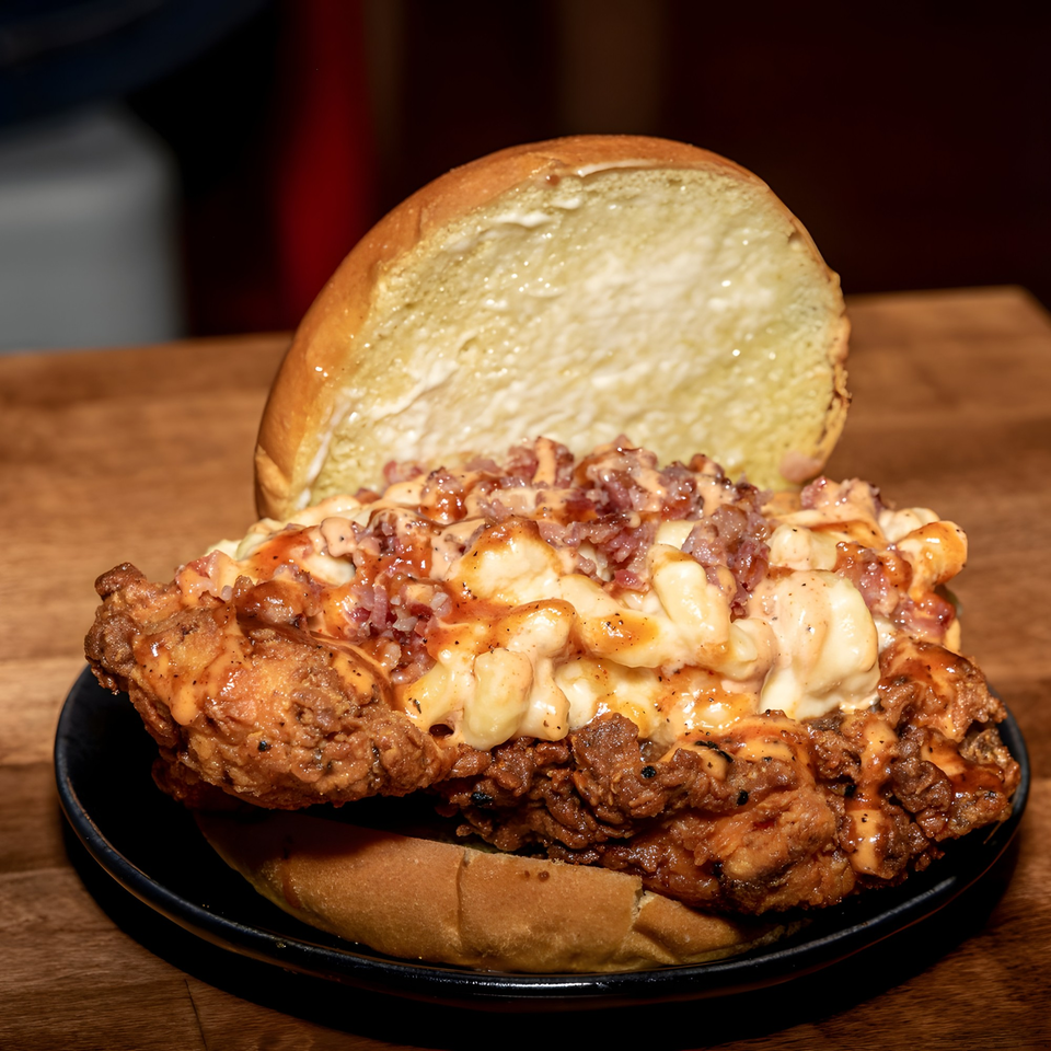 Fire Nashville Hot Chicken sandwich with fried chicken, mac and cheese, bacon, and sauce.
